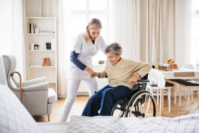 Caregiver Helping a Senior Woman to Stand Up